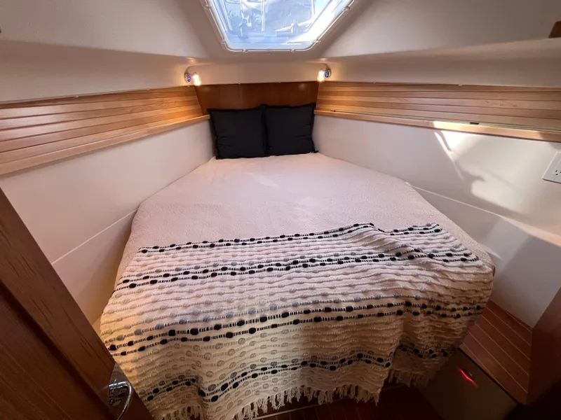 Slide: The Image of 2024 Catalina 355 yacht interior cabin with cozy bed and natural light. - 16