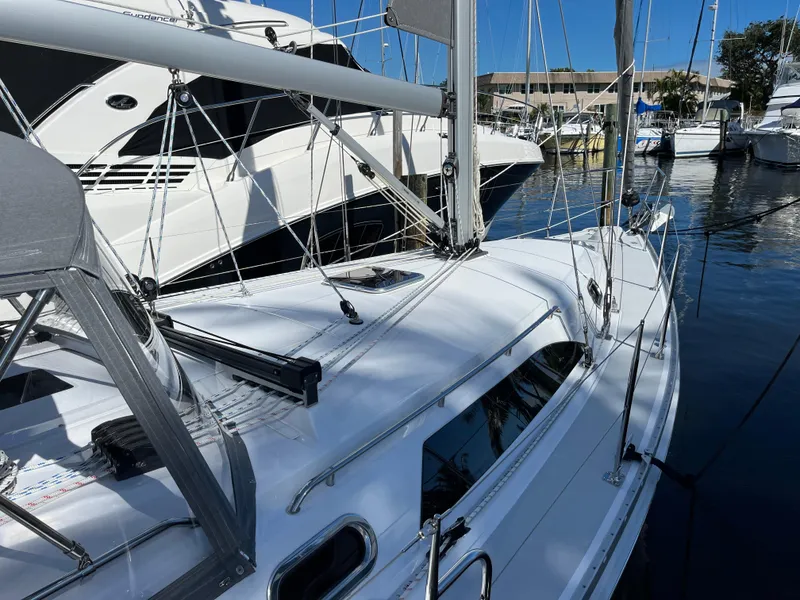 Slide: The Image of 2024 Catalina 355 sailboat docked at marina, featuring sleek design and modern rigging. - 2