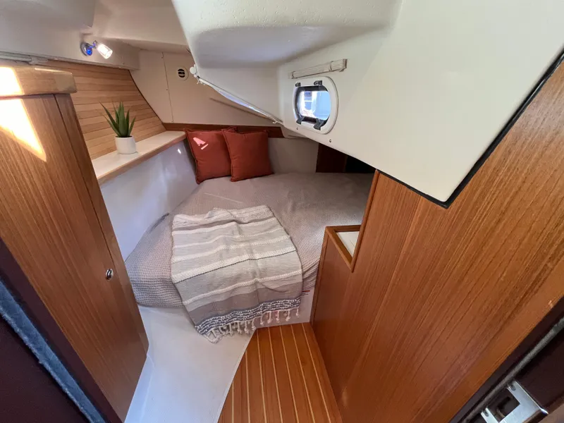 Slide: The Image of 2024 Catalina 355 yacht interior cabin with cozy bed and wooden finishes. - 20