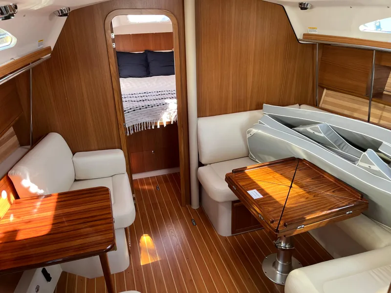 Slide: The Image of 2024 Catalina 355 yacht interior with wood finish, cozy seating, and elegant dining area. - 21