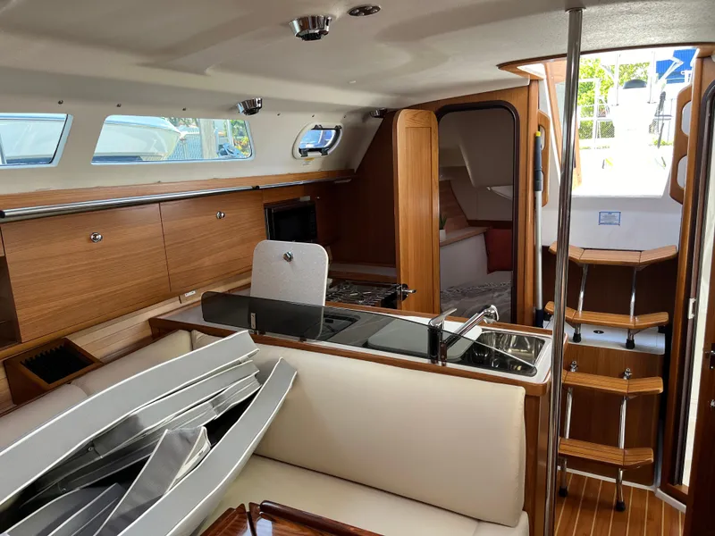 Slide: The Image of Interior of 2024 Catalina 355 sailboat with modern wood finish and seating area. - 22