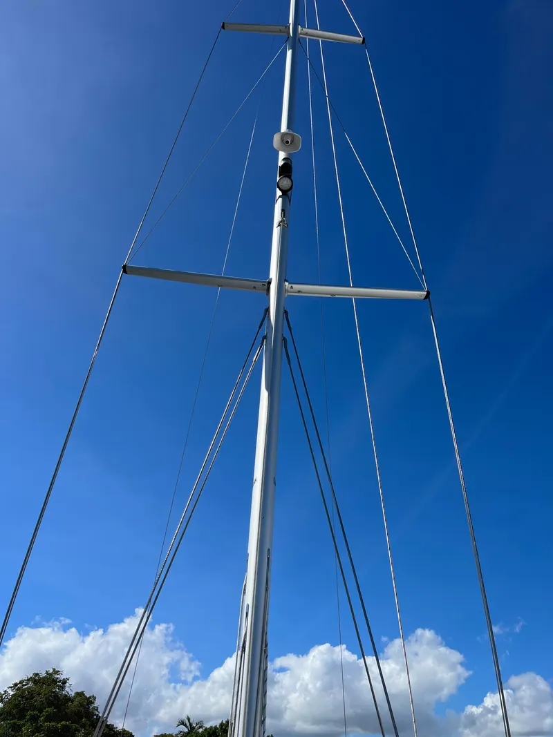 Slide: The Image of 2024 Catalina 355 sailboat mast against a clear blue sky. - 5