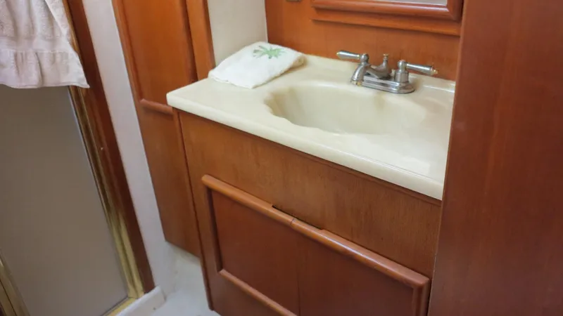 Slide: The Image of 1986 Post Sportfisher bathroom with wooden cabinetry and beige sink. - 16