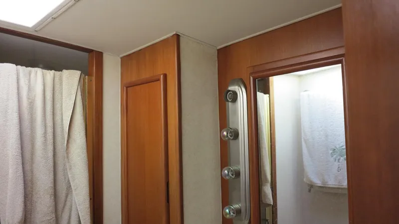 Slide: The Image of 1986 Post Sportfisher bathroom with wood paneling and shower curtain. - 17