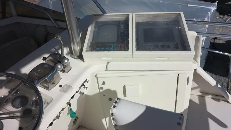 Slide: The Image of 1986 Post Sportfisher boat dashboard with navigation equipment and controls. - 19