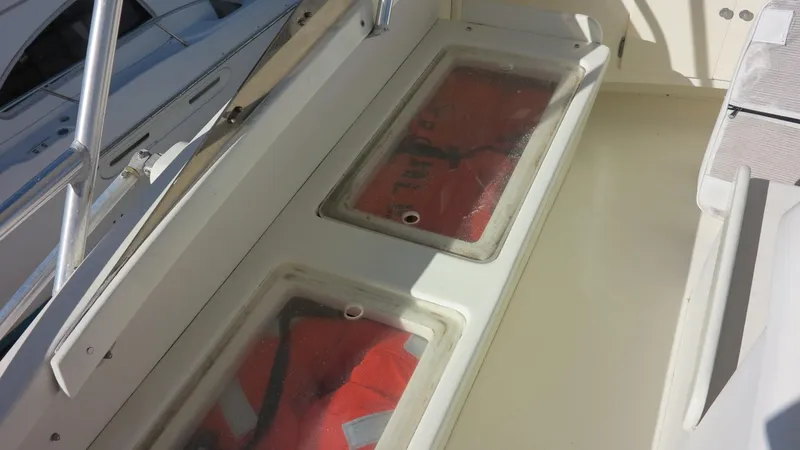 Slide: The Image of 1986 Post Sportfisher boat with life jackets stored under clear compartments. - 21