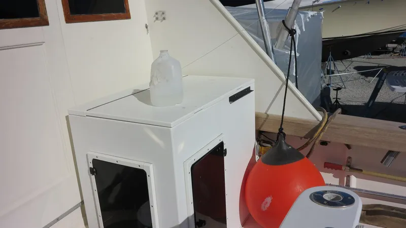 Slide: The Image of 1986 Post Sportfisher deck with storage box, water jug, and orange buoy. - 22