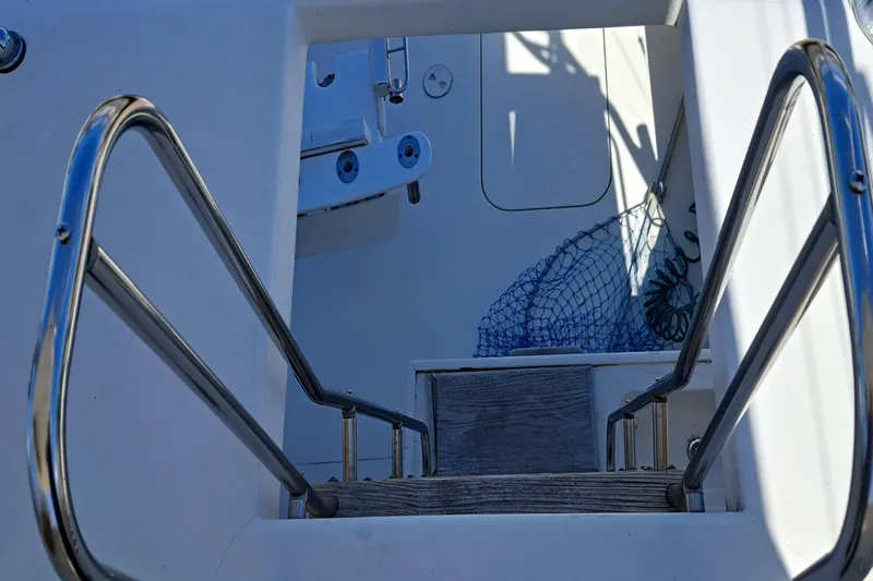 Slide: The Image of Staircase on a 1986 Post Sportfisher boat with metal railings and fishing net. - 32