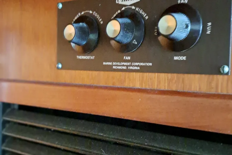 Slide: The Image of 1986 Post Sportfisher thermostat and fan control panel in wooden interior. - 39