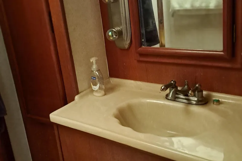Slide: The Image of 1986 Post Sportfisher bathroom sink with mirror and soap dispenser. - 40