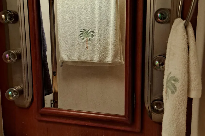 Slide: The Image of 1986 Post Sportfisher bathroom mirror with palm tree towels. - 41