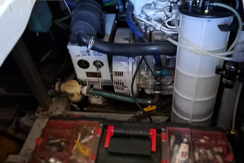 Slide: The Image of 1986 Post Sportfisher engine compartment with tools and mechanical components. - 44