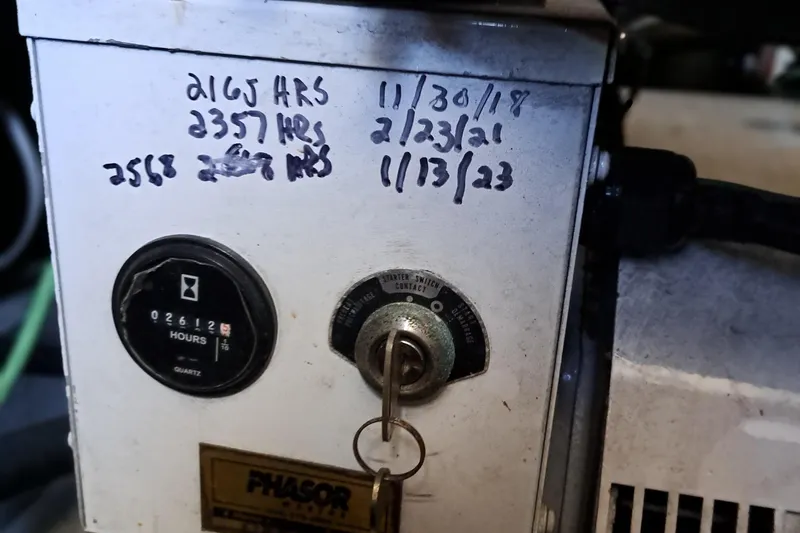 Slide: The Image of 1986 Post Sportfisher engine hours meter with key and maintenance dates. - 45