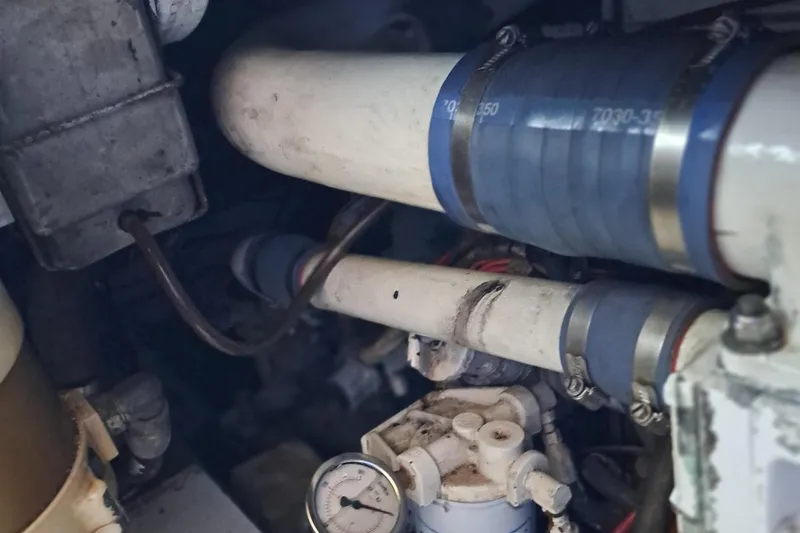 Slide: The Image of Engine compartment of a 1986 Post Sportfisher boat showing pipes and gauges. - 46