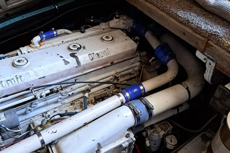 Slide: The Image of 1986 Post Sportfisher engine compartment with diesel engine and white piping. - 47