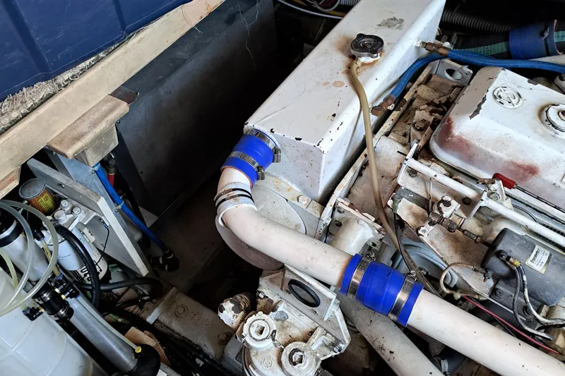 Slide: The Image of 1986 Post Sportfisher engine compartment with visible pipes and mechanical components. - 49