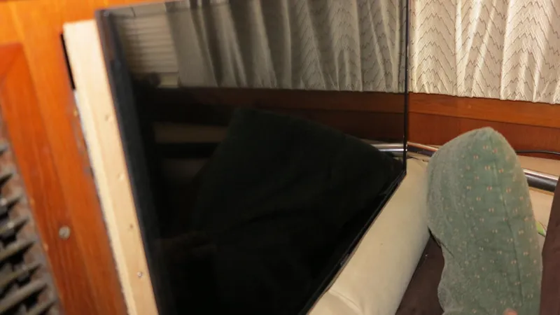 Slide: The Image of Interior of a 1986 Post Sportfisher boat with a mounted flat-screen TV. - 9