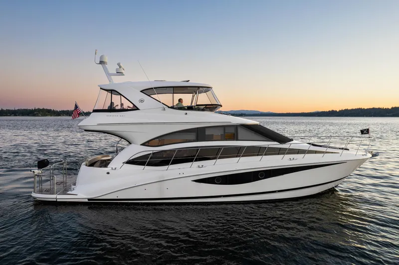 Slide: The Image of 2012 Meridian 541 Sedan yacht cruising at sunset on calm waters. - 1