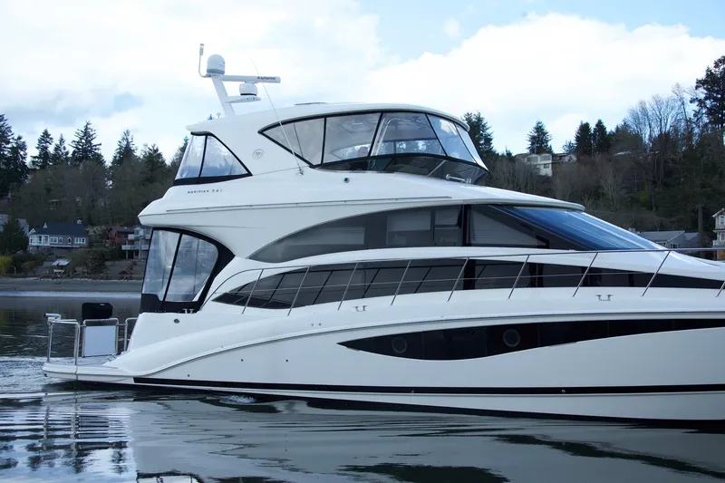 Slide: The Image of Luxury 2012 Meridian 541 Sedan yacht on calm water, surrounded by trees. - 17