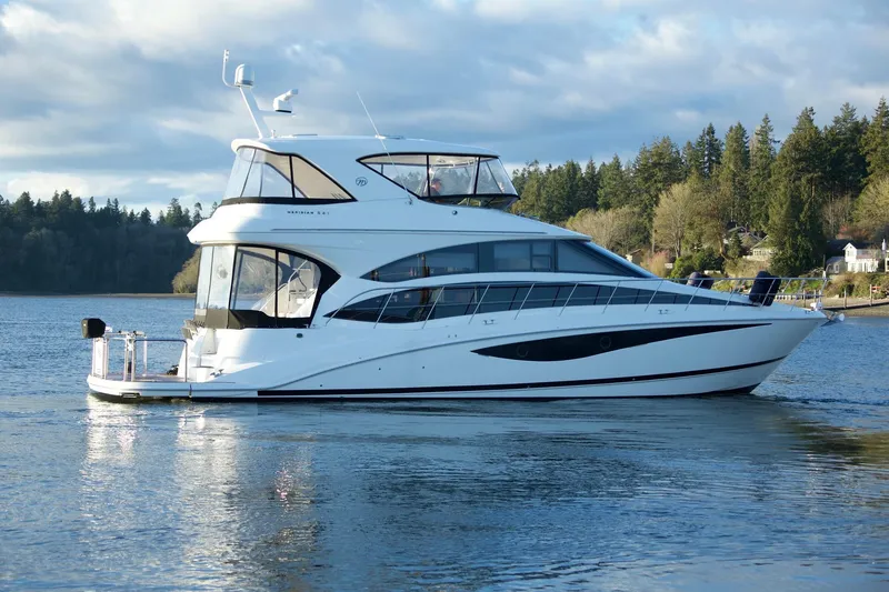 Slide: The Image of 2012 Meridian 541 Sedan yacht on a serene lake with forested shoreline. - 18