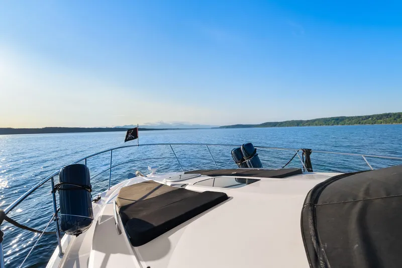 Slide: The Image of 2012 Meridian 541 Sedan yacht cruising on a serene blue lake under a clear sky. - 24