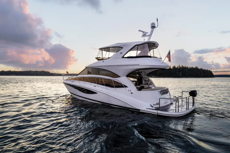 Slide: The Image of Luxury 2012 Meridian 541 Sedan yacht cruising at sunset on serene waters. - 3