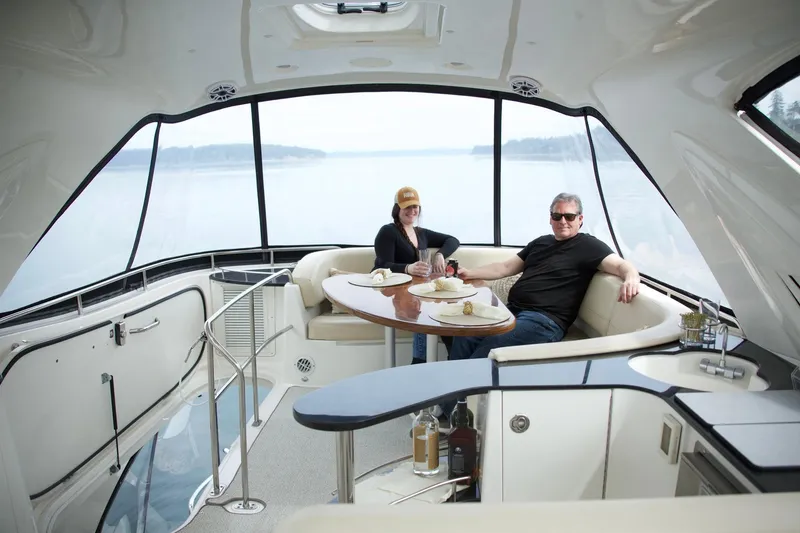 Slide: The Image of Two people relaxing in the luxurious interior of a 2012 Meridian 541 Sedan yacht. - 32