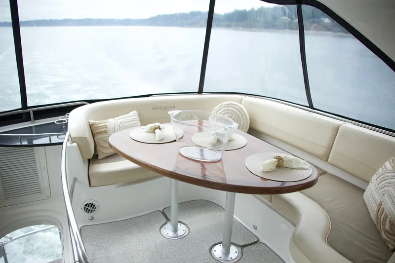 Slide: The Image of Luxurious 2012 Meridian 541 Sedan yacht interior with elegant dining area and scenic water view. - 33