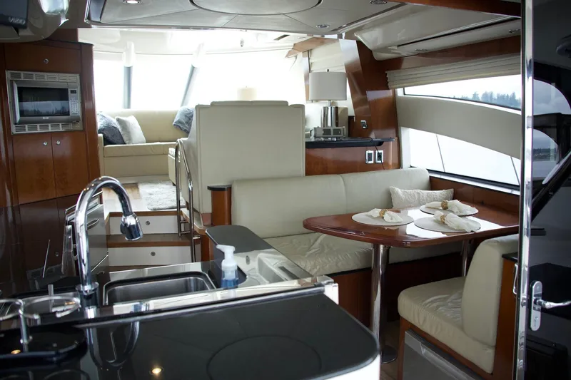 Slide: The Image of Luxurious interior of 2012 Meridian 541 Sedan yacht with modern kitchen and dining area. - 38