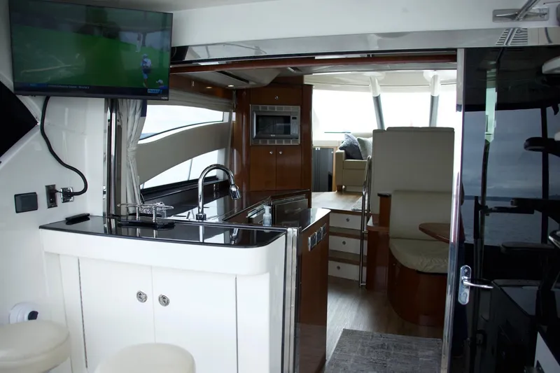 Slide: The Image of Interior of a 2012 Meridian 541 Sedan yacht with modern kitchen and seating area. - 39