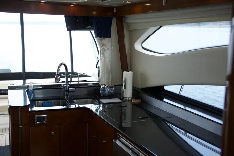 Slide: The Image of Interior of 2012 Meridian 541 Sedan yacht kitchen with sleek countertops and modern fixtures. - 44