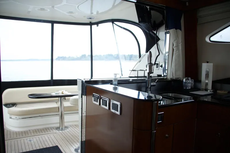 Slide: The Image of Interior of 2012 Meridian 541 Sedan yacht with kitchen and seating area. - 47