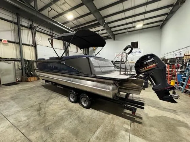 Slide: The Image of 2024 Avalon Catalina Rear J Lounger 23 FT pontoon boat in a warehouse. - 11