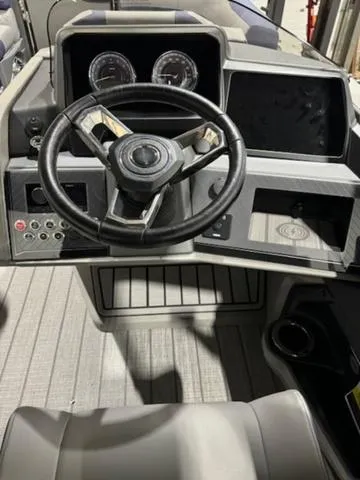 Slide: The Image of 2024 Avalon Catalina Rear J Lounger 23 FT boat with 175 horsepower engine in a warehouse. - 13