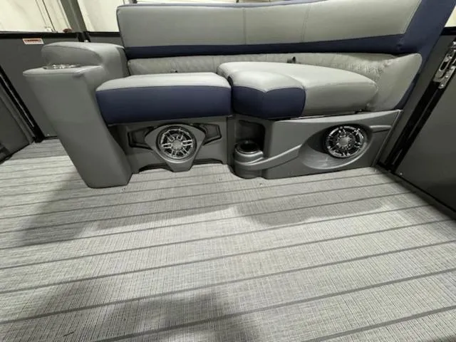Slide: The Image of 2024 Avalon Catalina Rear J Lounger 23 FT storage compartment open in a showroom. - 23