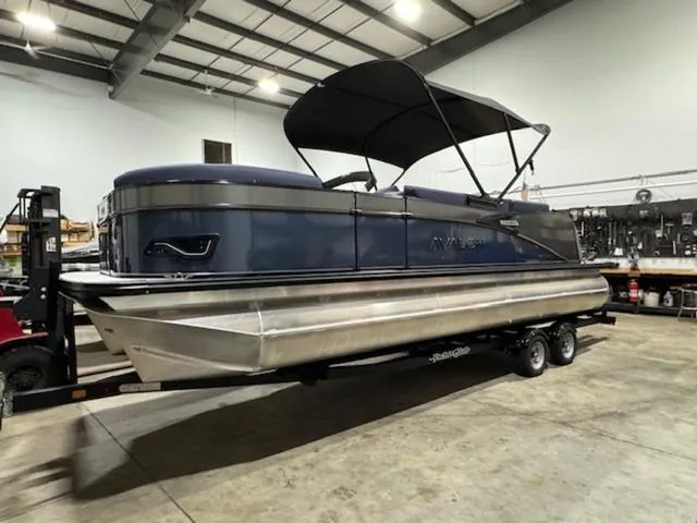 Slide: The Image of 2024 Avalon Catalina Rear J Lounger 23 FT pontoon boat in a warehouse. - 3
