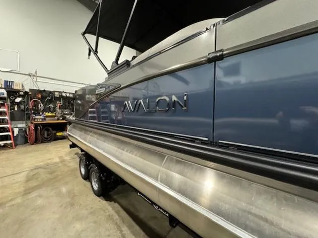 Slide: The Image of 2024 Avalon Catalina Rear J Lounger 23 FT boat in a garage setting. - 5
