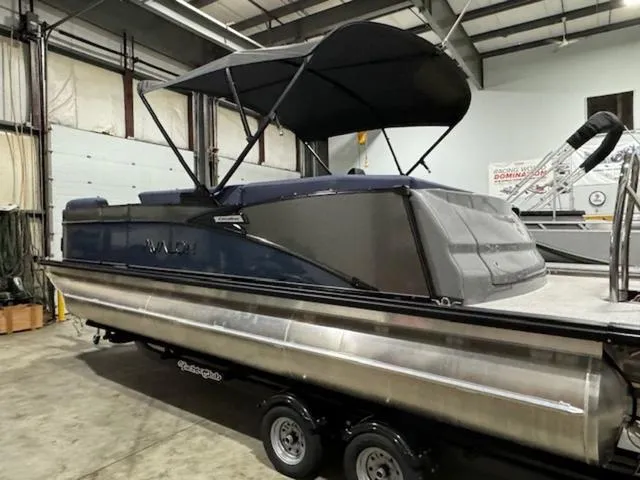Slide: The Image of 2024 Avalon Catalina Rear J Lounger 23 FT pontoon boat in a warehouse setting. - 6