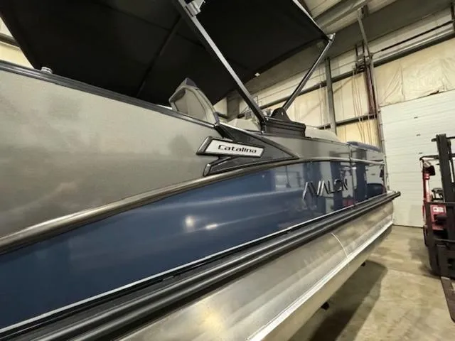 Slide: The Image of 2024 Avalon Catalina Rear J Lounger 23 FT pontoon boat in a warehouse. - 7