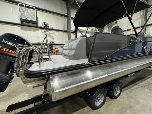 Slide: The Image of 2024 Avalon Catalina Rear J Lounger 23 FT pontoon boat in a warehouse setting. - 9