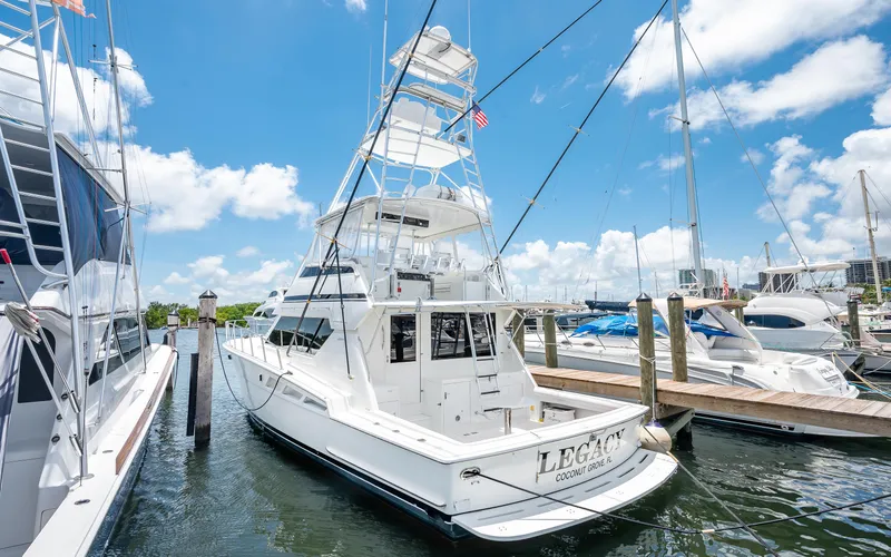 Slide: The Image of 1992 Hatteras 50 Convertible yacht docked at marina on a sunny day. - 13