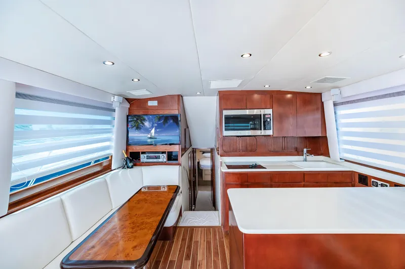 Slide: The Image of Interior of 1992 Hatteras 50 Convertible yacht with modern kitchen and dining area. - 20