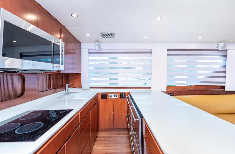 Slide: The Image of Modern kitchen interior of 1992 Hatteras 50 Convertible yacht with sleek wood cabinetry. - 23