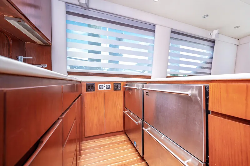Slide: The Image of Modern kitchen area in a 1992 Hatteras 50 Convertible yacht with stainless steel appliances. - 24