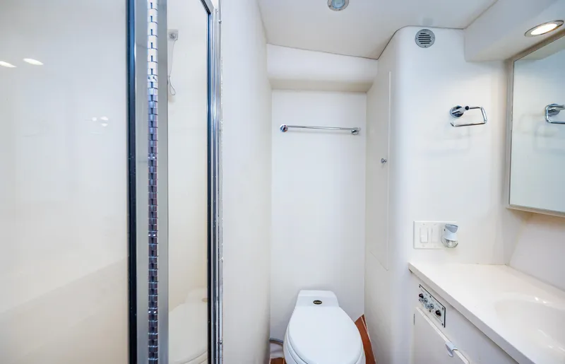 Slide: The Image of 1992 Hatteras 50 Convertible yacht bathroom with shower, toilet, and vanity. - 27