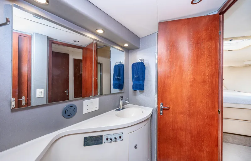 Slide: The Image of 1992 Hatteras 50 Convertible yacht bathroom with modern fixtures and wooden door. - 29