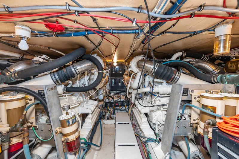 Slide: The Image of Engine room of a 1992 Hatteras 50 Convertible yacht with detailed wiring and machinery. - 32