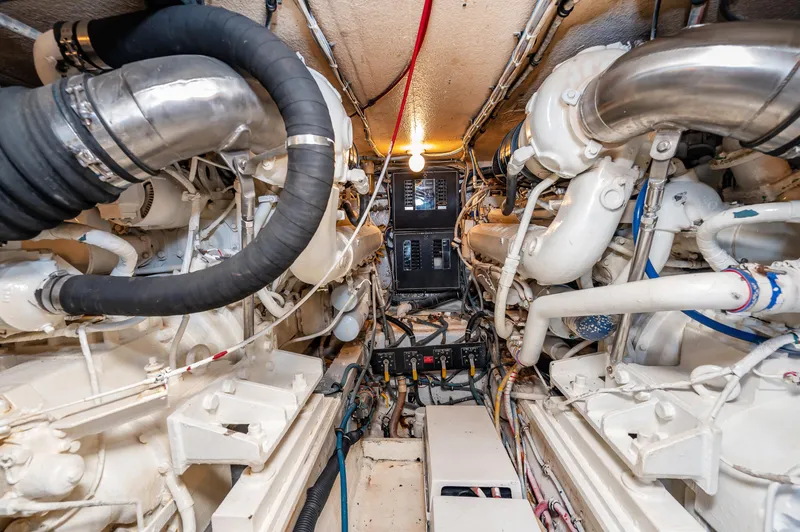 Slide: The Image of Engine room of a 1992 Hatteras 50 Convertible yacht with dual engines. - 33