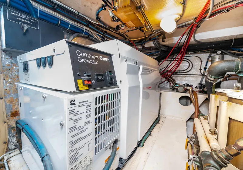 Slide: The Image of Engine room of a 1992 Hatteras 50 Convertible with Cummins Onan generator. - 34