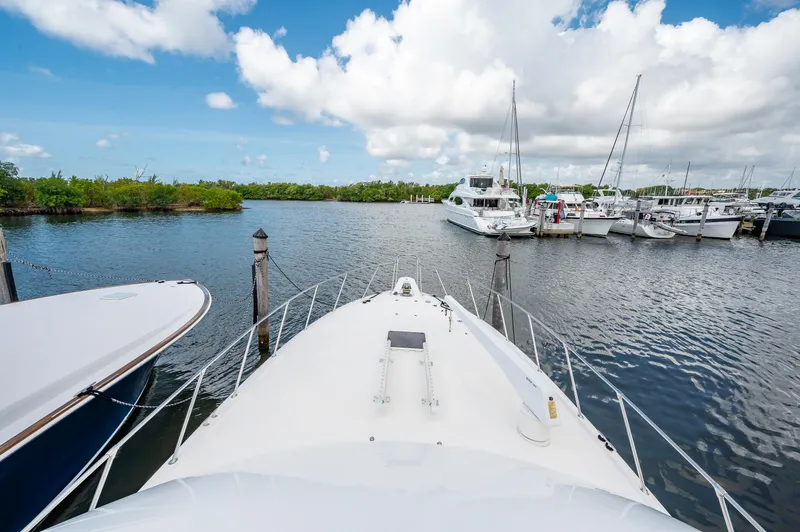 Slide: The Image of Bow view of 1992 Hatteras 50 Convertible yacht docked at marina. - 4